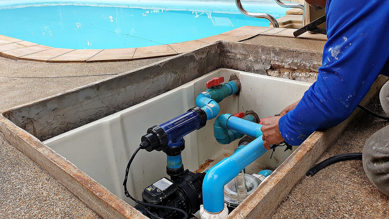 Pool professional testing water chemistry and inspecting filtration equipment with precision tools