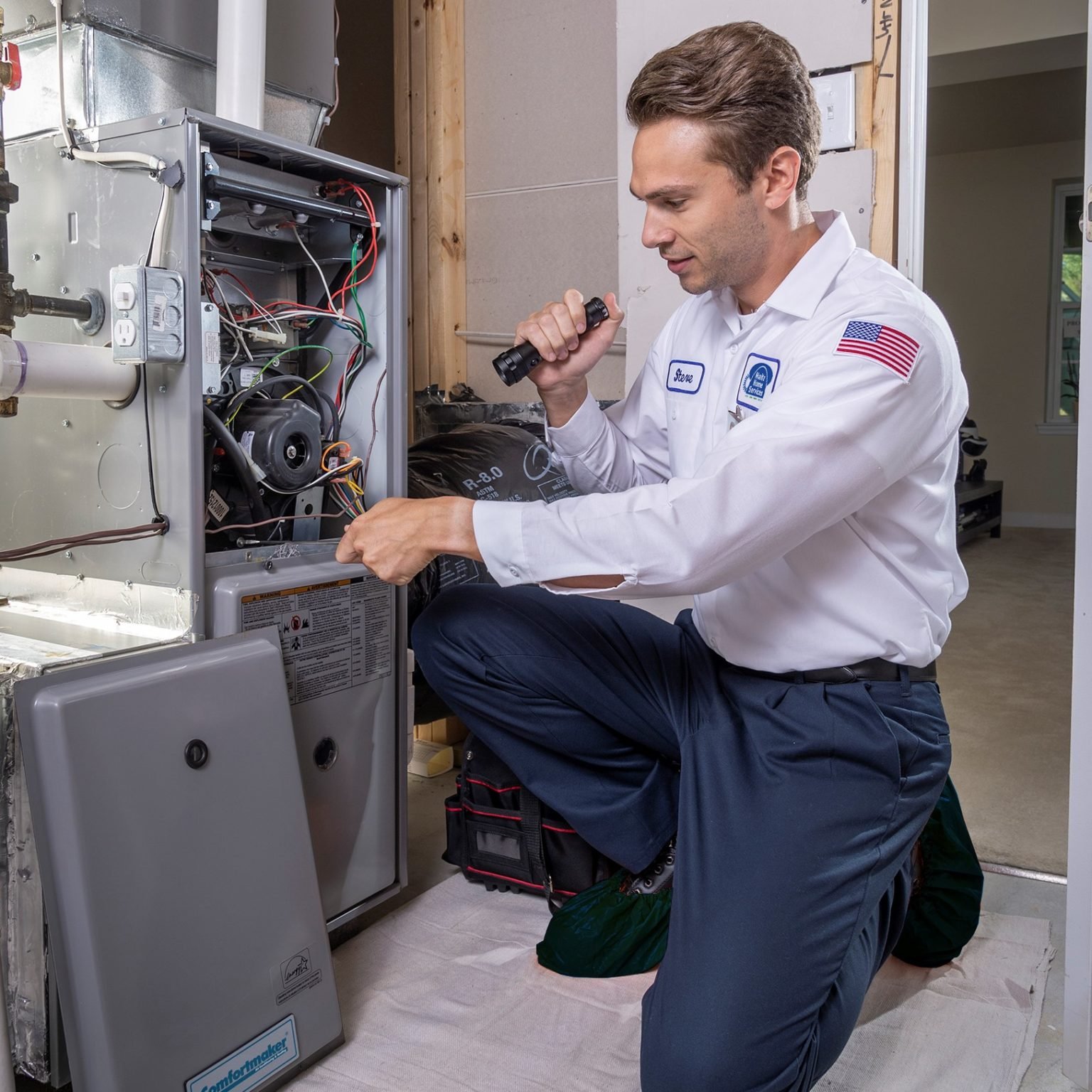 Experienced HVAC technician inspecting components and airflow for system performance