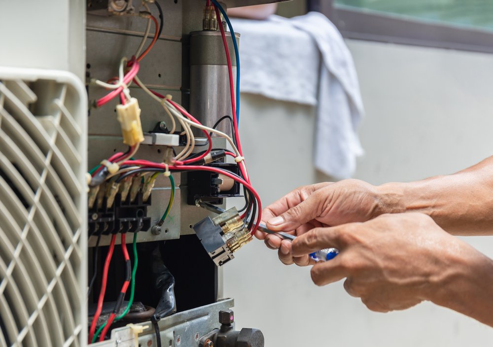 Technician repairing home furnace after cold morning heating failure